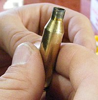 Inspecting a .243 Winchester case for defects